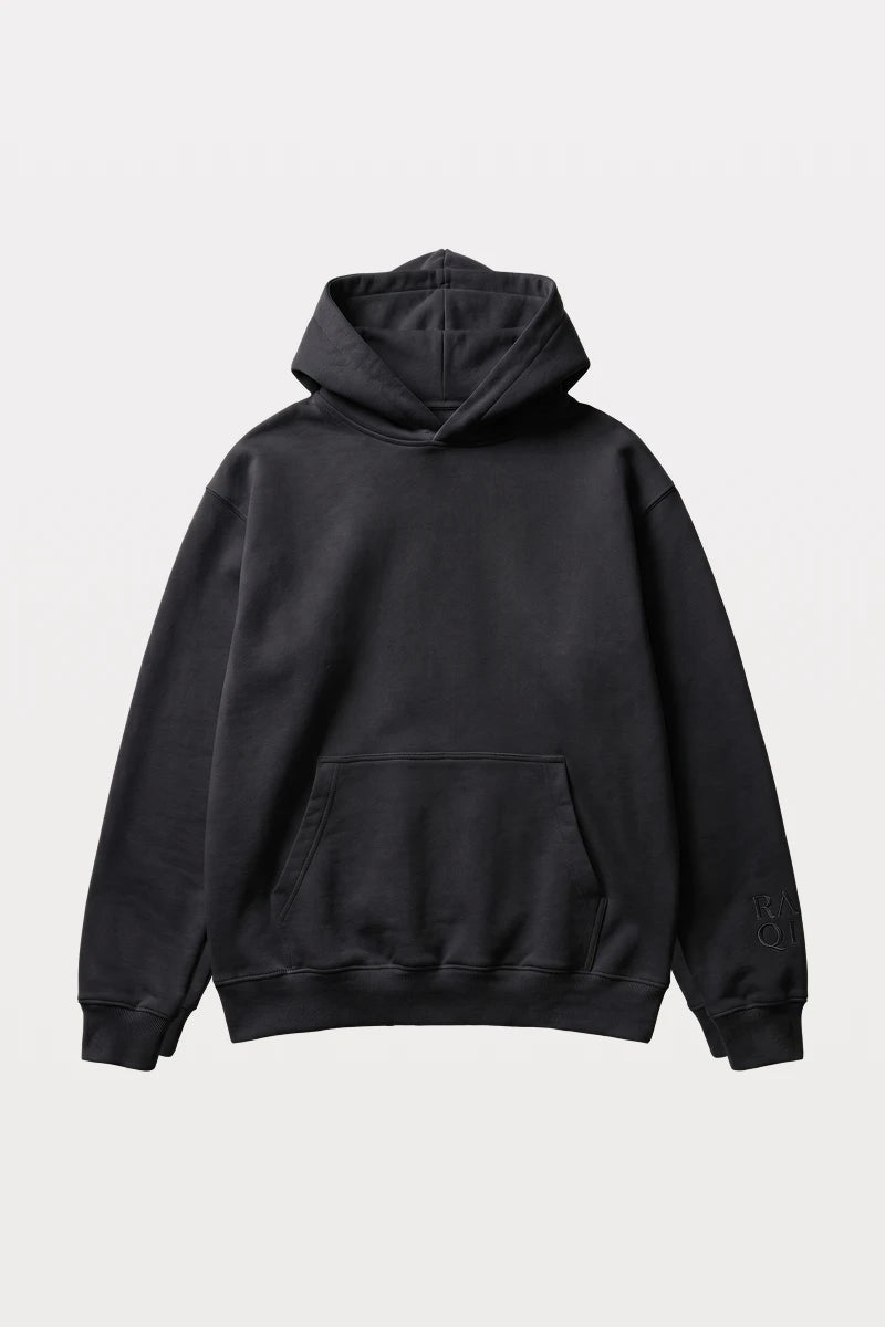 RAQI black essential pullover hoodie with a relaxed fit, kangaroo pocket, and tonal sleeve logo branding.