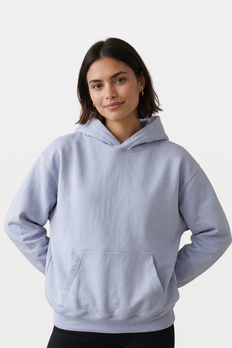 RAQI sky blue pullover hoodie with a structured hood, kangaroo pocket, and subtle tonal sleeve embroidery on a model